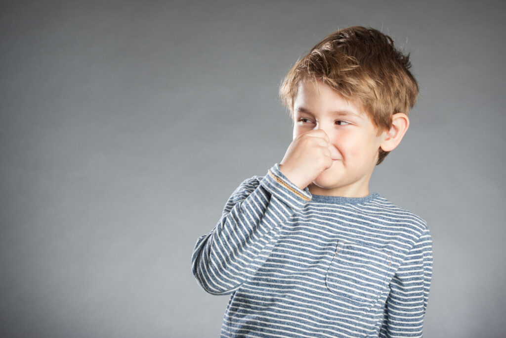 H2S smells bad - Illustration image of little boy holding his nose.